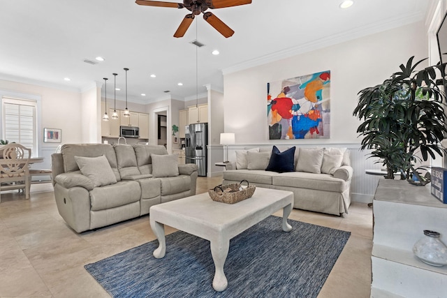 living room with crown molding and ceiling fan