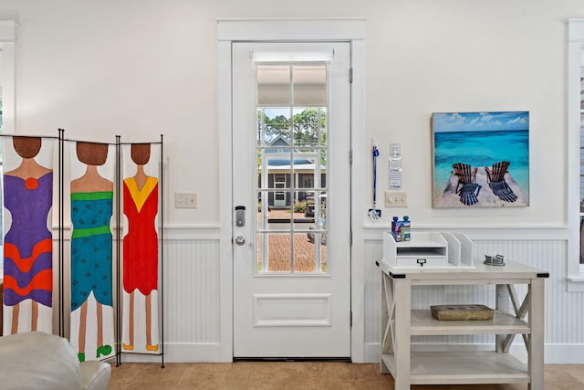 doorway to outside with light tile patterned floors