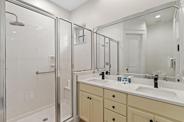 bathroom with vanity and a shower with shower door