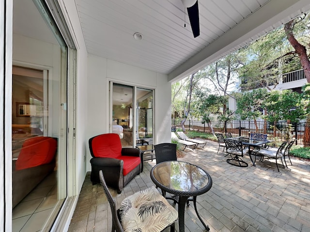 view of patio with outdoor dining space and fence