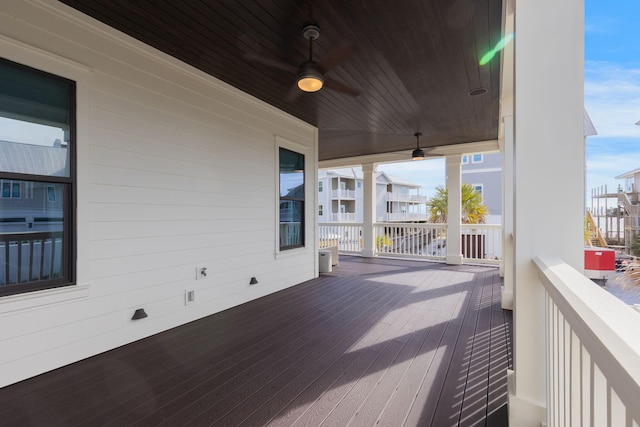 wooden terrace featuring a porch and ceiling fan