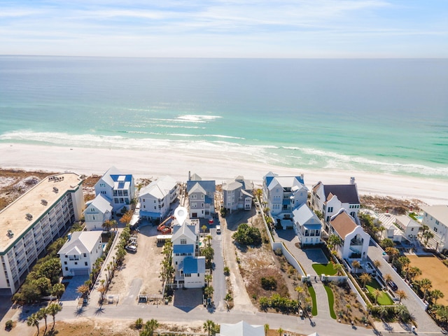 drone / aerial view featuring a water view and a beach view