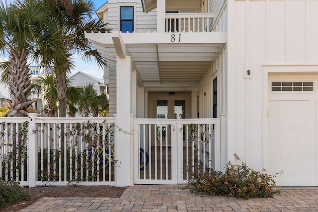 view of exterior entry featuring a balcony