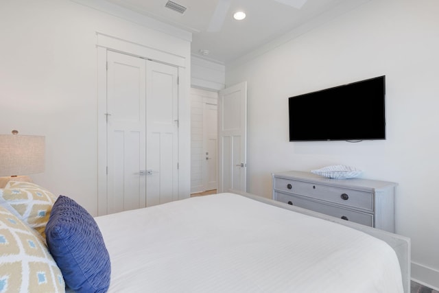 bedroom featuring ornamental molding and a closet