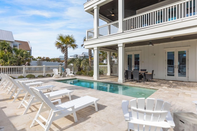 view of pool with a patio area, ceiling fan, and french doors