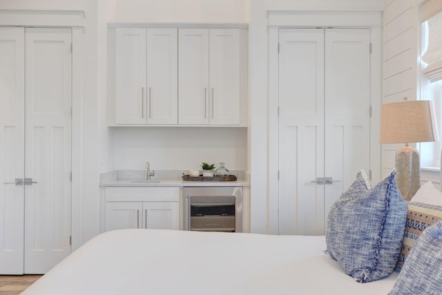 bedroom with indoor wet bar and wine cooler