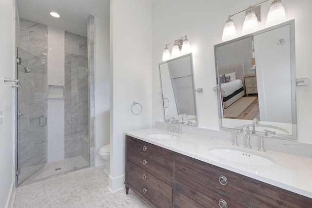 bathroom with vanity, toilet, and a shower with door