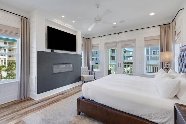 bedroom featuring hardwood / wood-style flooring, access to outside, and ceiling fan