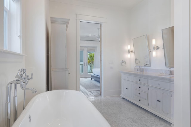 bathroom with vanity and a washtub