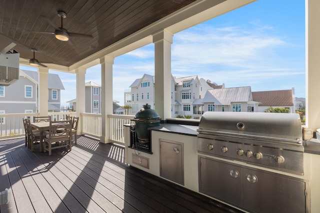 deck featuring ceiling fan, an outdoor kitchen, and grilling area