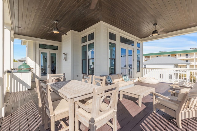 wooden terrace with an outdoor living space, french doors, and ceiling fan