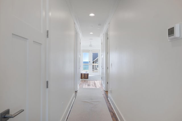 hallway featuring ornamental molding