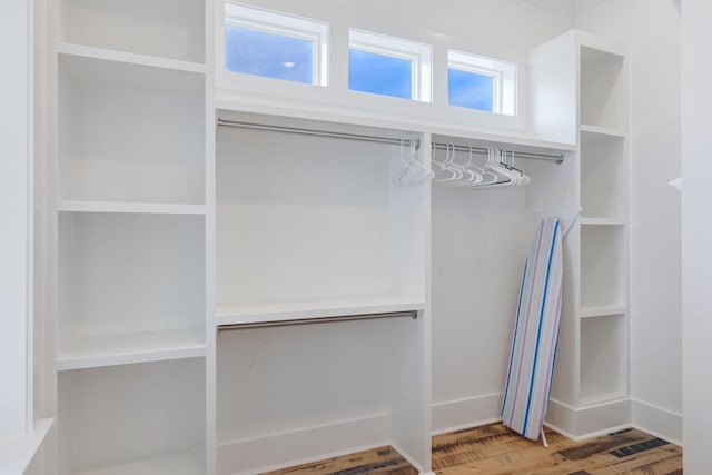 spacious closet with hardwood / wood-style flooring