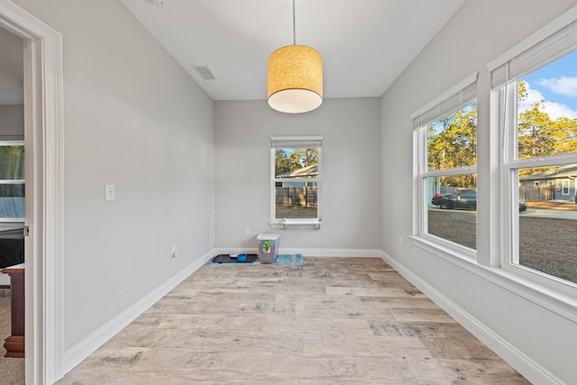 unfurnished dining area with light hardwood / wood-style flooring