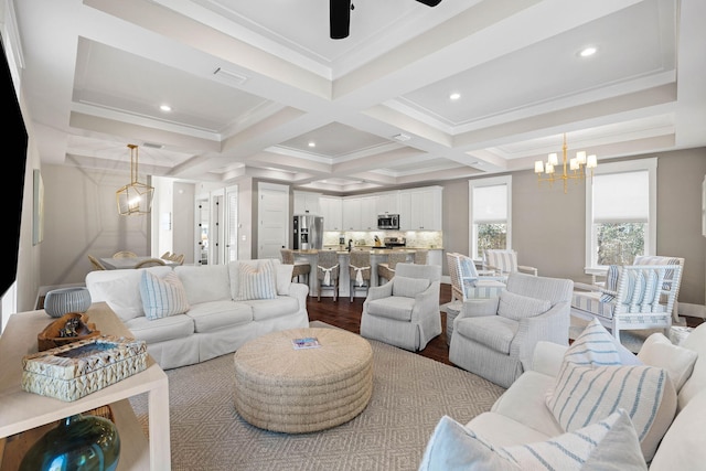 living room featuring ceiling fan with notable chandelier, wood-type flooring, ornamental molding, coffered ceiling, and beam ceiling