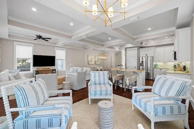 living room with coffered ceiling, beam ceiling, wood-type flooring, and ceiling fan with notable chandelier