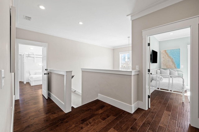 hall featuring ornamental molding and dark hardwood / wood-style flooring