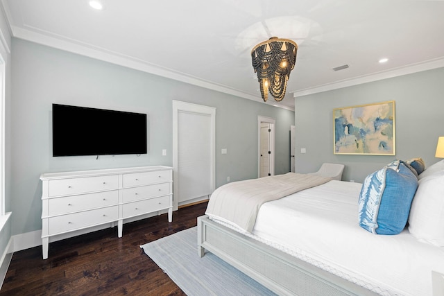 bedroom with dark wood-type flooring, crown molding, and a chandelier