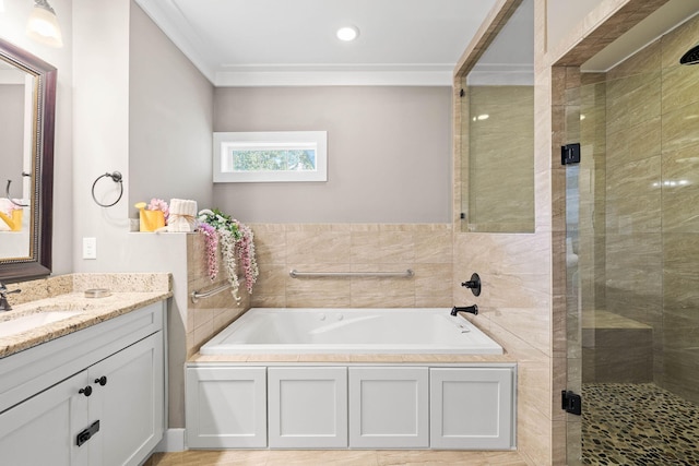 bathroom with ornamental molding, vanity, and shower with separate bathtub