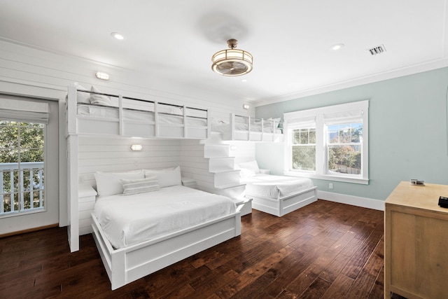 bedroom with crown molding and dark hardwood / wood-style floors