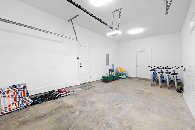 garage with a garage door opener and electric panel