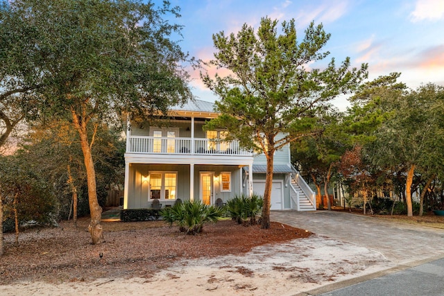 view of front of house featuring a balcony and a garage