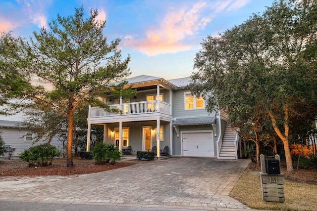 view of front of house featuring a garage and a balcony