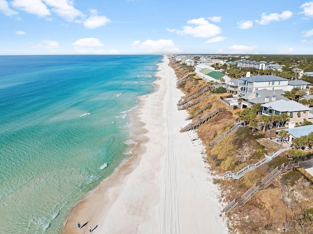 birds eye view of property featuring a water view and a beach view