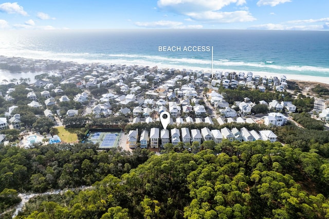 birds eye view of property featuring a water view and a view of the beach