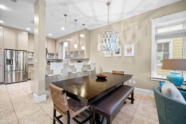 dining space with a chandelier and light tile patterned floors