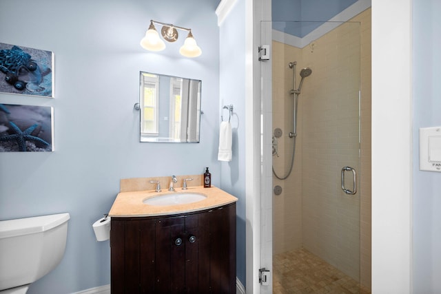 bathroom featuring vanity, toilet, and an enclosed shower