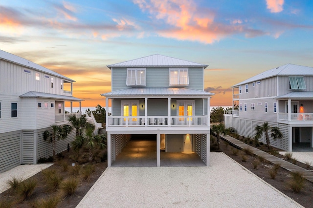 raised beach house featuring french doors and a carport