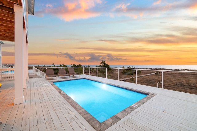 pool at dusk with a water view