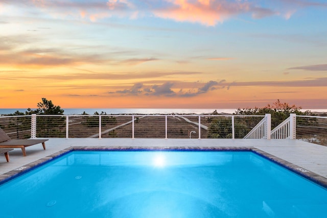 pool at dusk with a water view