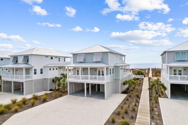 back of house featuring a carport and a water view