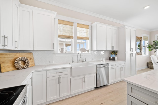 kitchen featuring stainless steel appliances, sink, and white cabinets