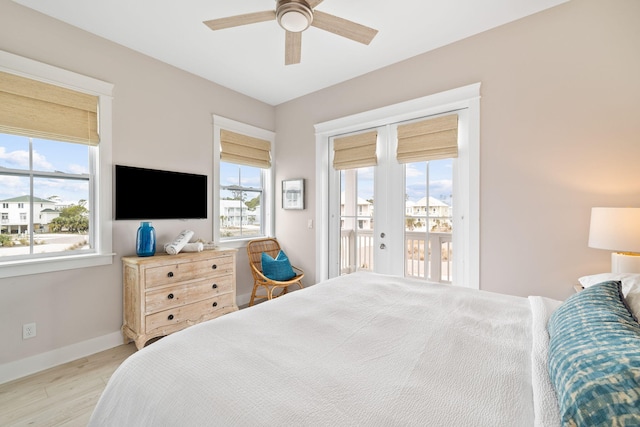 bedroom featuring access to exterior, light hardwood / wood-style flooring, french doors, and ceiling fan