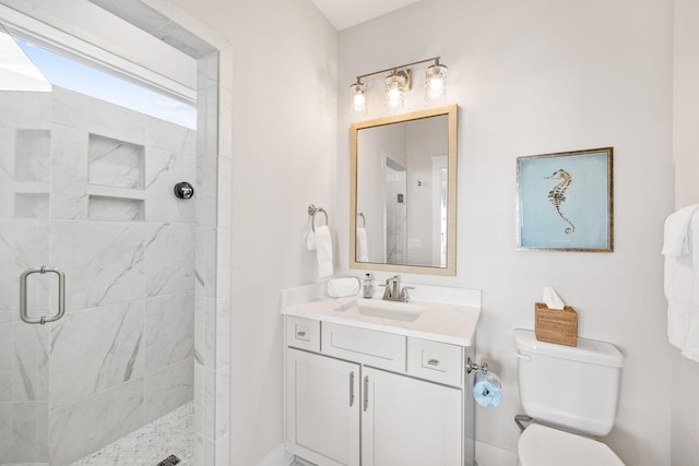 bathroom with walk in shower, vanity, and toilet