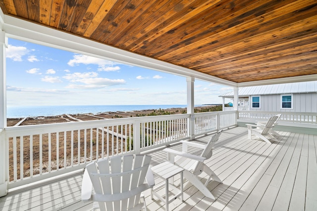 deck featuring a view of the beach and a water view