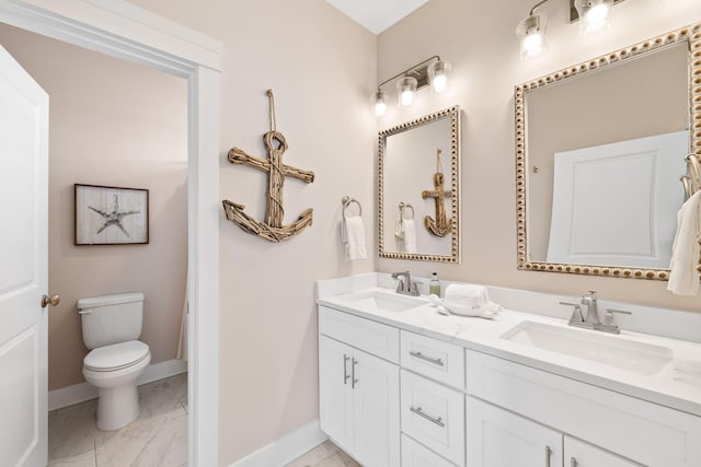 bathroom featuring vanity and toilet