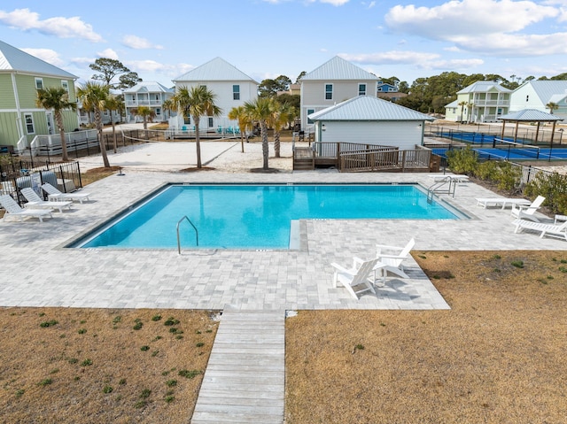 view of swimming pool with a patio, a yard, and a deck