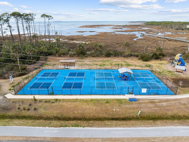 view of pool with tennis court and a water view