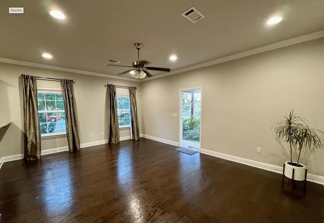 empty room featuring crown molding, dark wood-type flooring, and ceiling fan