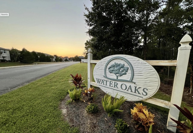 community / neighborhood sign with a lawn