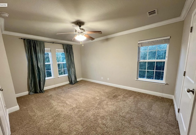 empty room with crown molding, carpet floors, and ceiling fan