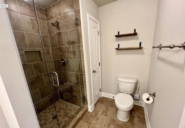 bathroom featuring walk in shower, tile patterned floors, and toilet