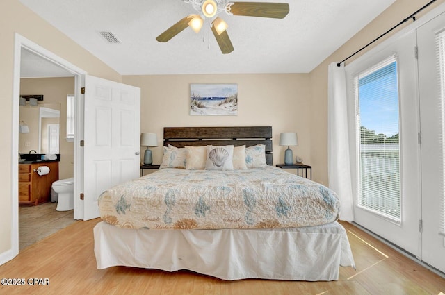 bedroom with hardwood / wood-style flooring, ceiling fan, access to exterior, and a textured ceiling