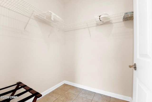 spacious closet with tile patterned floors