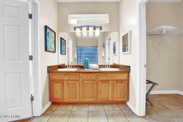 bathroom with walk in shower, vanity, and tile patterned flooring