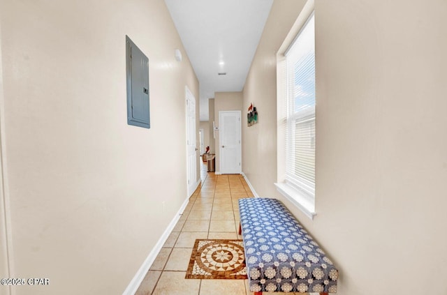 hallway featuring tile patterned flooring and electric panel